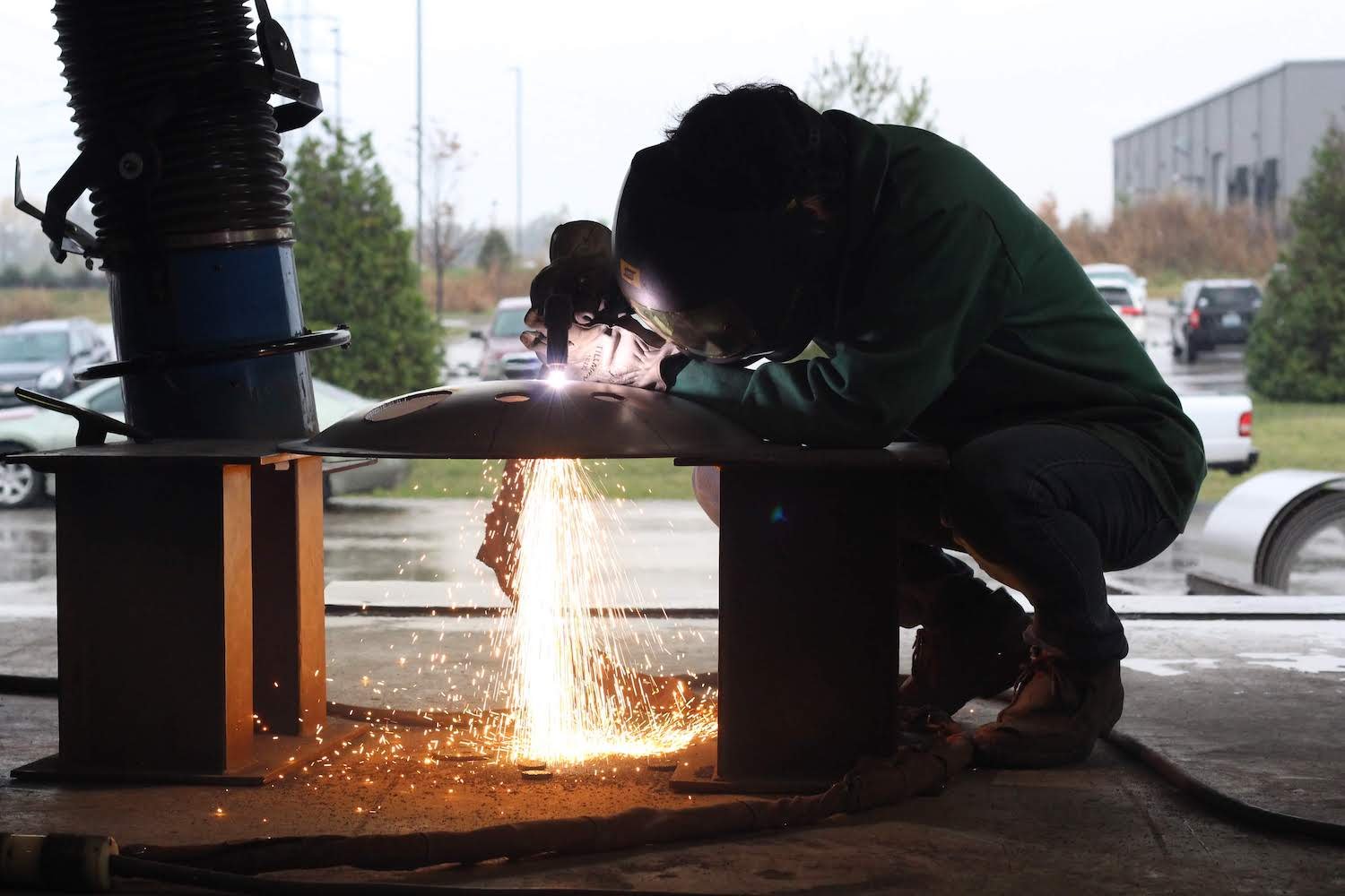 Welder welding round tank lid