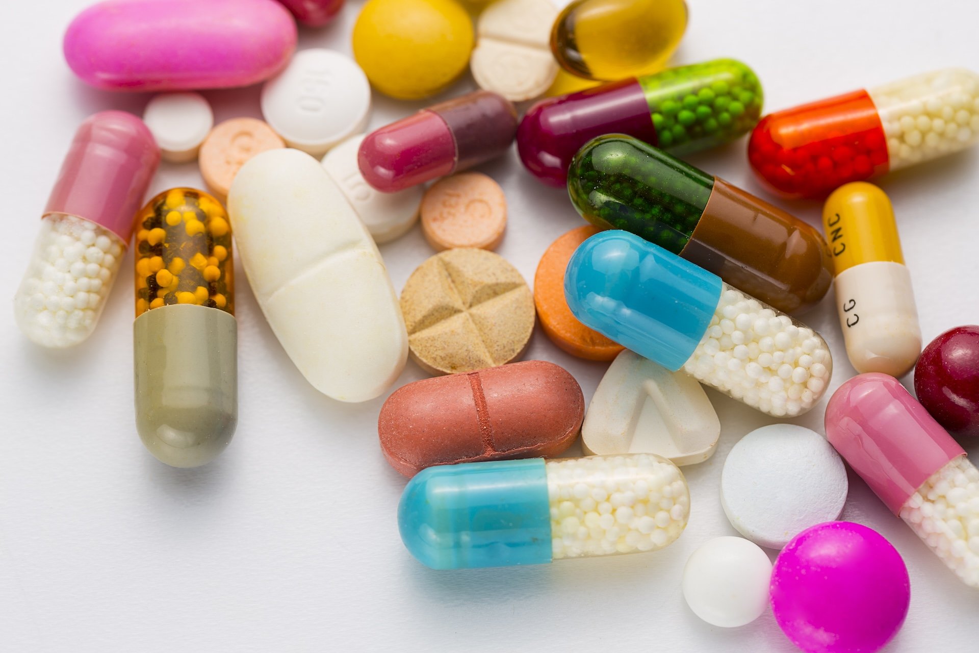 collection of small, multi-colored pills and capsules